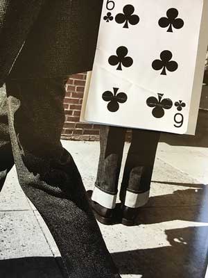 The photographs are comprised of a Six of Clubs found in the street along with magazine advertisements.