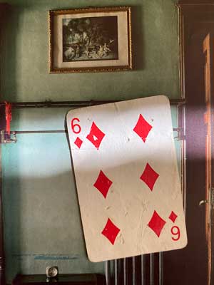 Photograph of a playing card of the Six of Diamonds found in the street