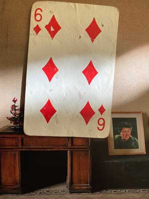 Photograph of a playing card of the Six of Diamonds found in the street