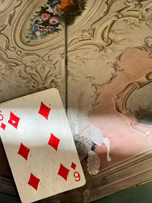 Photograph of a playing card of the Six of Diamonds found in the street