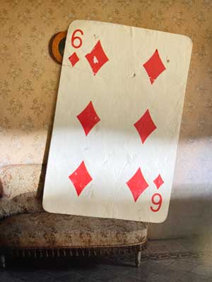 Photograph of a playing card of the Six of Diamonds found in the street