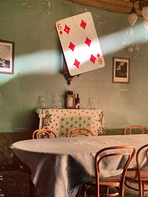 Photograph of a playing card of the Six of Diamonds found in the street